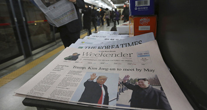 A newspaper with headline of a planned summit meeting between North Korean leader Kim Jong Un and U.S. President Donald Trump, left, is displayed at a subway station in Seoul