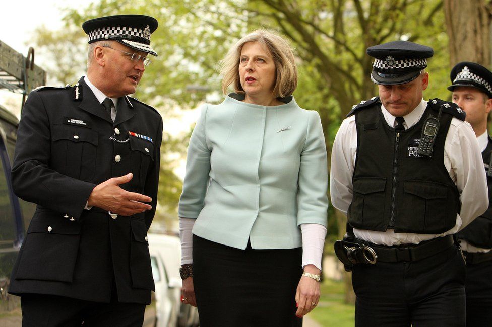 Theresa May with two police officers