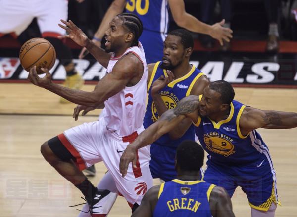 Toronto Raptors forward Kawhi Leonard (2) drives past Golden State Warriors forward Kevin Durant (35) and Warriors forward Andre Iguodala (9) during first half Game 5 NBA Finals basketball action in Toronto on Monday, June 10, 2019. THE CANADIAN PRESS/Nathan Denette