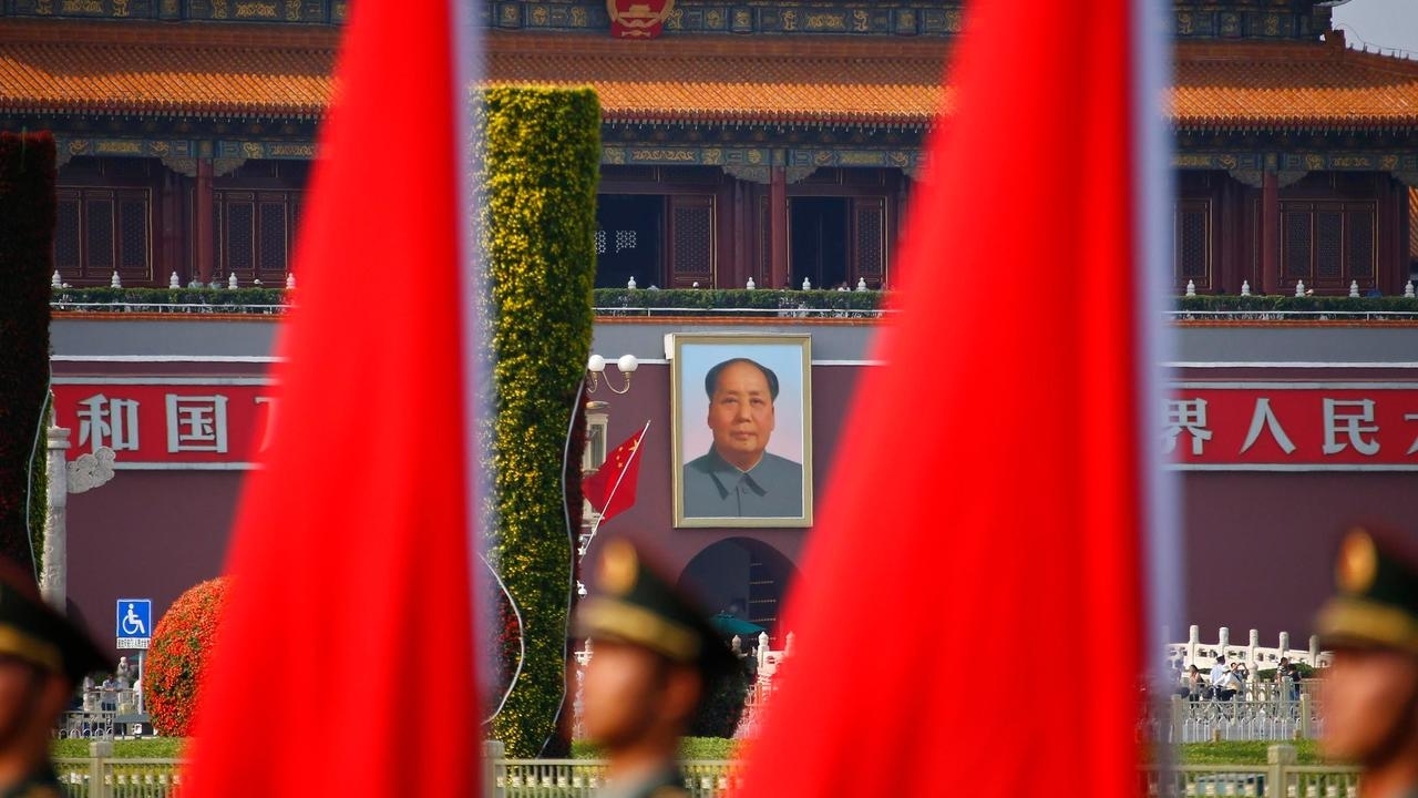 Soldiers from the honour guards of the Chinese People's Liberation Army (PLA) line up against a backdrop of a portrait of late chairman Mao Zedong hanging on the Tiananmen Gate, during a welcoming ceremony for Kuwait's Prime Minister Sheikh Jaber al-Mubara
