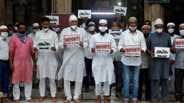 Muslims wearing protective face masks hold placards as they pay tribute to Indian army soldiers, who were killed in a border clash with Chinese troops in Ladakh region last month, and demand to boycott China-made products, after a prayer meeting at a mosque in Ahmedabad, India, July 3, 2020