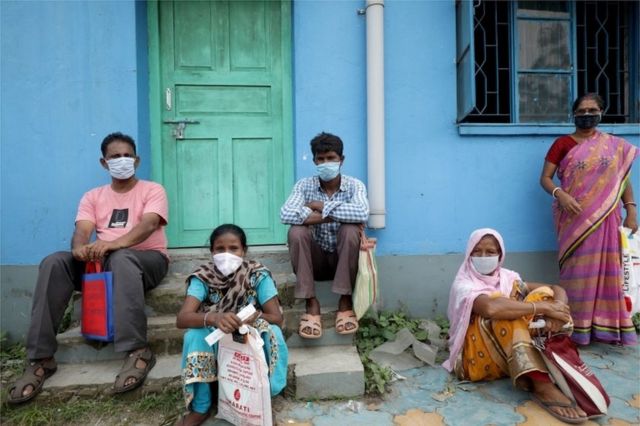 Locals wear protective face masks at government test center in Kolkata,