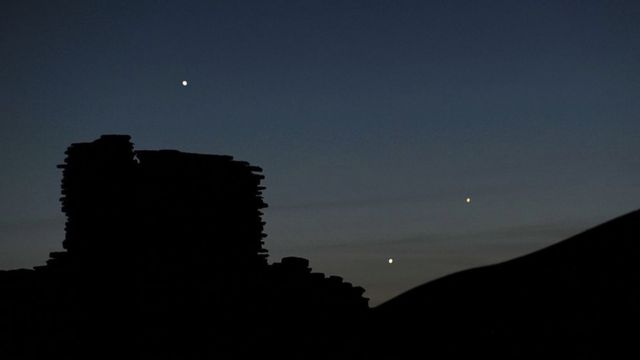The planets Jupiter (L), Venus (C) and Mercury (R) are seen in an unusual conjunction.