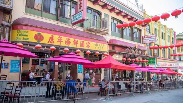 People eat outside a restaurant in San Francisco's Chinatown