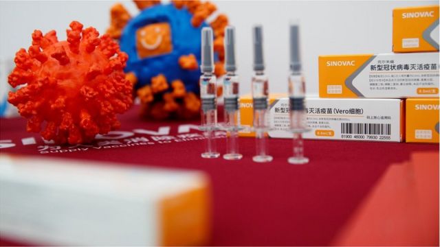 A display shows vaccine products of Sinovac Biotech during a government-organized media tour showcasing the company