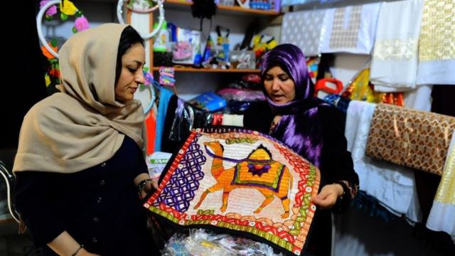 An Afghan shop with a buyer and seller