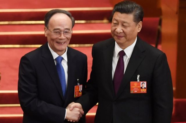 习近平与新当选的国家副主席王岐山握手。