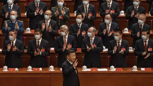 Chinese President Xi Jinping, right, is applauded as he waves to senior members of the government as he arrives to the Opening Ceremony of the 20th National Congress of the Communist Party of China at The Great Hall of People on October 16, 2022 in Beijing, China.
