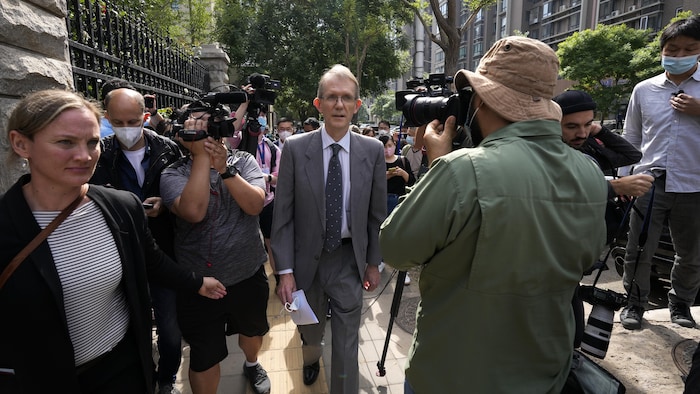 Australian ambassador to China Graham Fletcher, center, is surrounded by reporters outside the No. 2 Intermediate People's Court after he was denied to attend the espionage charges case for Yang Hengjun, in Beijing, Thursday, May 27, 2021. Fletcher said it was regrettable that the embassy was denied access Thursday as a trial was due to start for Yang, a Chinese Australian man charged with espionage. (AP Photo/Andy Wong)
